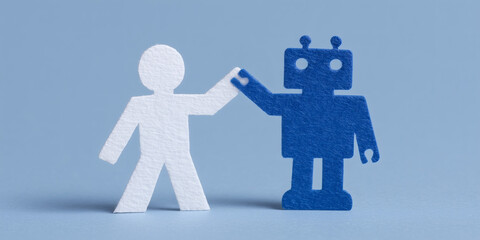 Mensch und Roboter aus Papier in einer Geste der Einigung. Symbolisiert die positive Integration von KI und Mensch am Arbeitsplatz der Zukunft. Digitalisierung der Arbeit