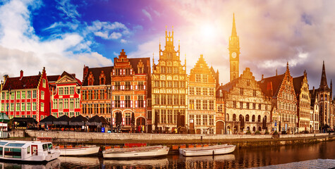 Ghent city historical center, tourists boats and colorful buildings on Leie river bank, Belgium
