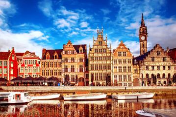 Obraz premium Ghent city historical center, tourists boats and colorful buildings on Leie river bank, Belgium