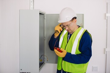 Electrician performing diagnostics using multimeter on electrical panel