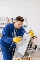 Technician working on hydraulic press machine in workshop