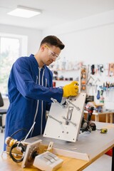 Technician working on a prototype in a modern laboratory