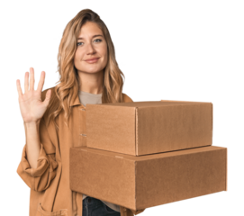 Blonde Caucasian moving with large boxes smiling cheerful showing number five with fingers.