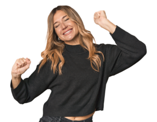 Caucasian blonde woman in studio dancing and having fun.