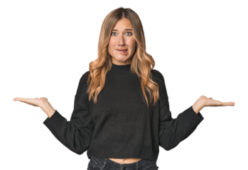 Caucasian blonde woman in studio confused and doubtful shrugging shoulders to hold a copy space.