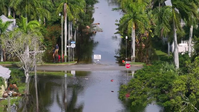Hurricane Milton aftermath in Punta Gorda, Florida. City street closed because of flooding with warning signs blocking driving of cars.