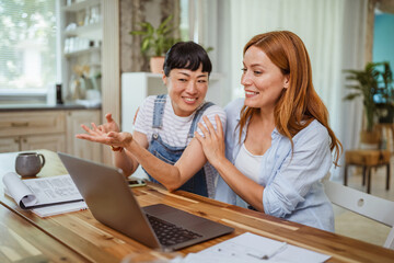 multicultural female friends discussing on video call at home