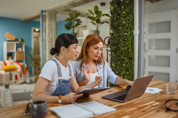 Fototapeta premium multicultural female friends discussing and working or teaching at home