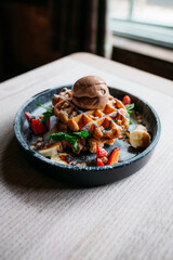 A dessert with a waffle and ice cream on top