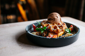 A dessert with a chocolate sauce and strawberries on top