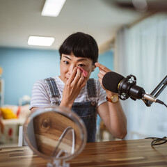 under the shoulder view of japanese host record podcast at home studio
