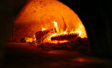 A wood burning fire in a brick oven