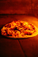 Italian pizza is cooked in a wood-fired oven.
