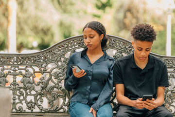 young bored couple looking at their phones