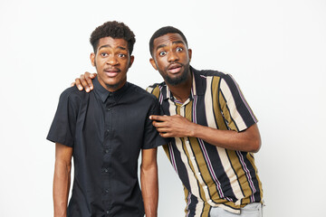Two surprised African American men express excitement and curiosity, showcasing unique styles and...