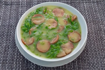 Traditional winter soup known as Portuguese green broth prepared good potatoes, kale and sausage. The best Portuguese broth in the world