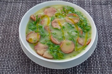 Traditional winter soup known as Portuguese green broth prepared good potatoes, kale and sausage. The best Portuguese broth in the world