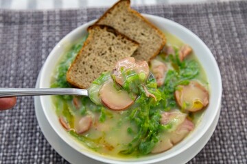 Traditional winter soup known as Portuguese green broth prepared good potatoes, kale and sausage. The best Portuguese broth in the world