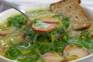 Traditional winter soup known as Portuguese green broth prepared good potatoes, kale and sausage. The best Portuguese broth in the world