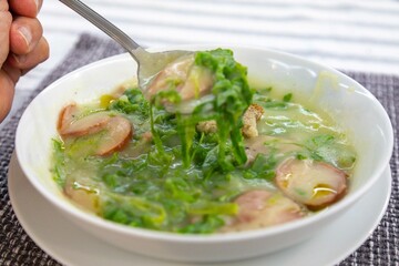 Traditional winter soup known as Portuguese green broth prepared good potatoes, kale and sausage. The best Portuguese broth in the world