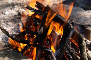 Burning coals in a fire at night.