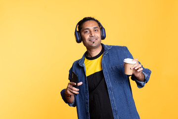 Funky person having fun with headset and dancing on oriental rhythm, enjoying poses in the studio....