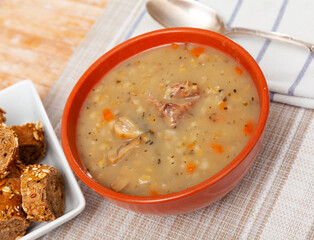 Hearty homemade soup with mushroom, pork, vegetables and pearl barley