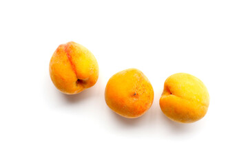 Fresh ripe apricots on a white background.