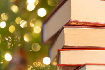 Close-Up of Stacked Books with Bokeh Background.Books on Christmas and winter themes