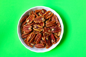 Delicious salted pecan nuts scattered.