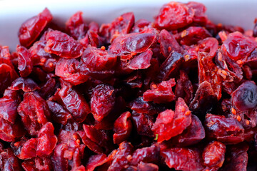 Dried cranberries piled on a white background