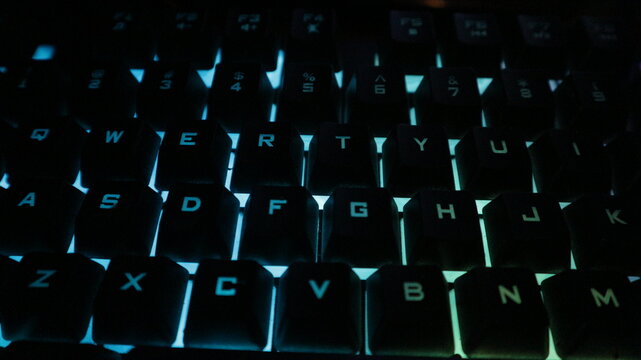 Close-up view of a backlit computer keyboard with illuminated keys.