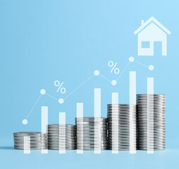 Increase in real estate value. Stacked coins, house icon, graph and percent signs against light...