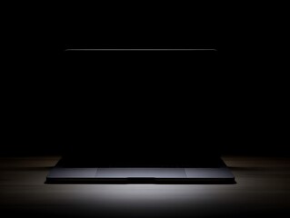 Laptop illuminated by a single light source.
