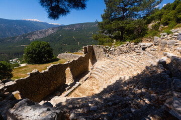 View of remains of ancient odeon in Lycian settlement of Arycanda on scenic background of mountain...