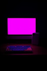 A computer desk setup illuminated with vibrant purple light.