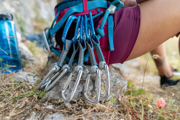 Close-up of climbing carabiners on a woman climber's waist