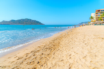 View from a sandy beach in the Golden Zone resort area of Mazatlan, Mexico, of seaside resorts along the Mexican Riviera.	