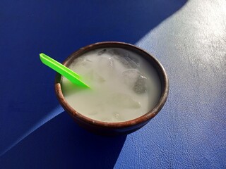 Refreshing Coconut Milk Drink with Ice and Green Straw
