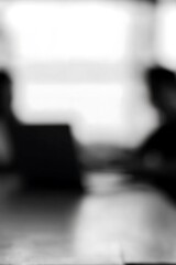 Abstract grayscale image of indistinct figures.