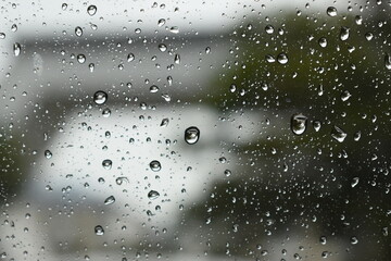 water drop on mirror in rainy day, blur natural background