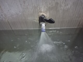 Water Flowing from Tap into Traditional Bathroom Tub