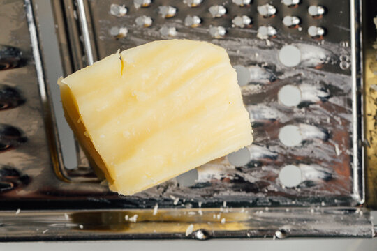 little brick of mozzarella cheese on box grater