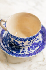 empty vintage ceramic patterned Made in Japan teacup and saucer on white