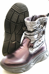 Fashion snow boots . Winter gray  black shoes. Warm waterproof boots. Protection in the cold winter. Blue white background