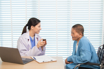 Fototapeta premium Female doctor consulting senior patient across table, pointing at laptop screen while discussing treatment plan in professional and friendly healthcare environment, illness, hospitality.