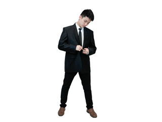 Young Asian man in a black suit and tie, standing against a white background in casual pose