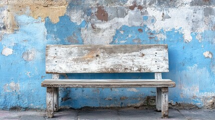 Rustic wooden bench resting against a vibrant textured wall, evocative vintage vibe