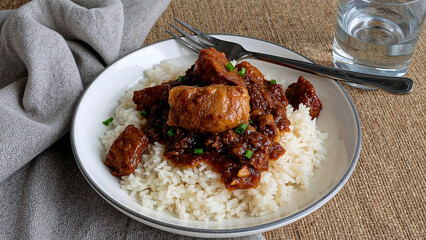 Delicious philippine adobo served with garlic rice