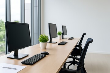 Modern Office Workspace with Multiple Computers, Plants, and Natural Light in Bright, Minimalist Interior Design